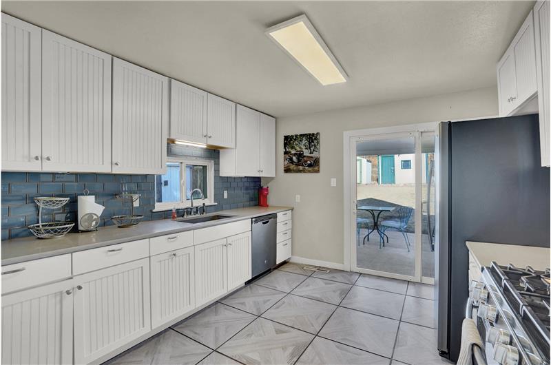 The Kitchen offers tile floors and white cabinets with quartz countertops