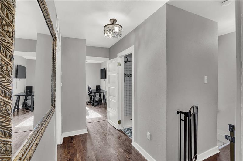 Upper level hallway with hardwood floors