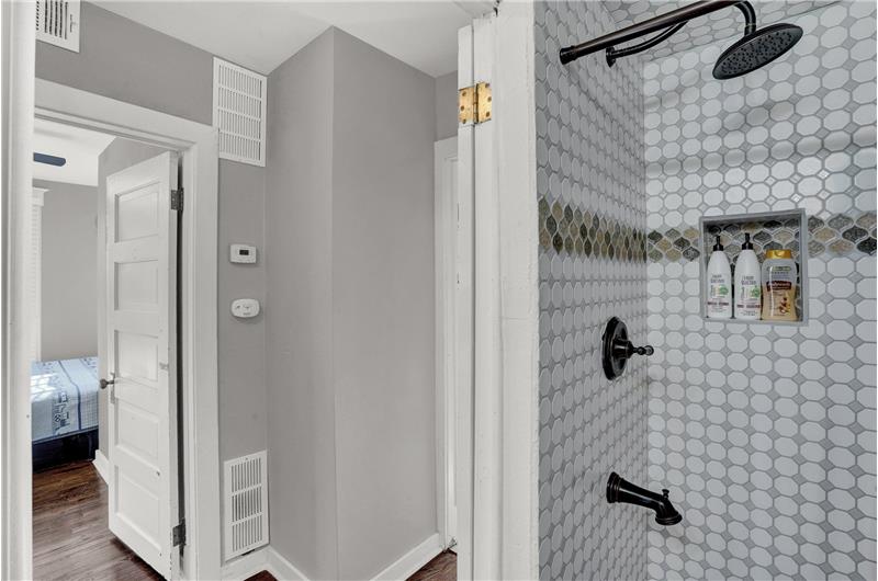 Upper level tiled shower with rain shower head