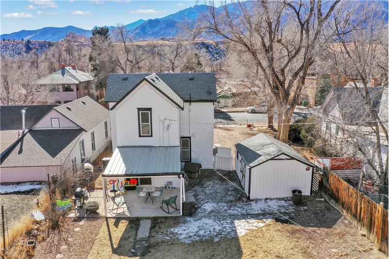 Daytime views of the rear of the home and detached garage