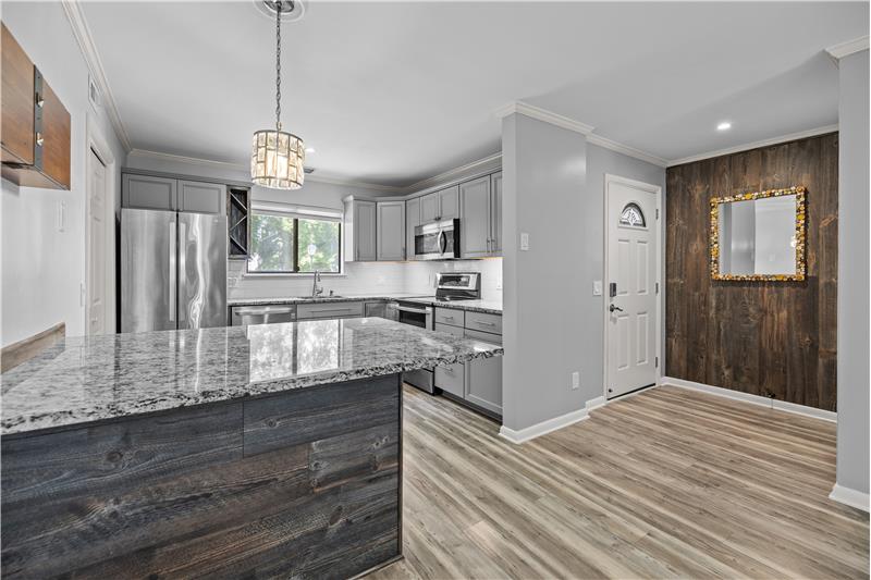 Open sight lines from foyer to kitchen with granite island