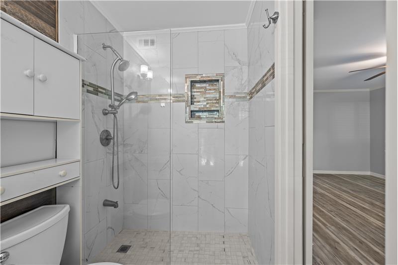Primay bathroom with spa-inspired shower