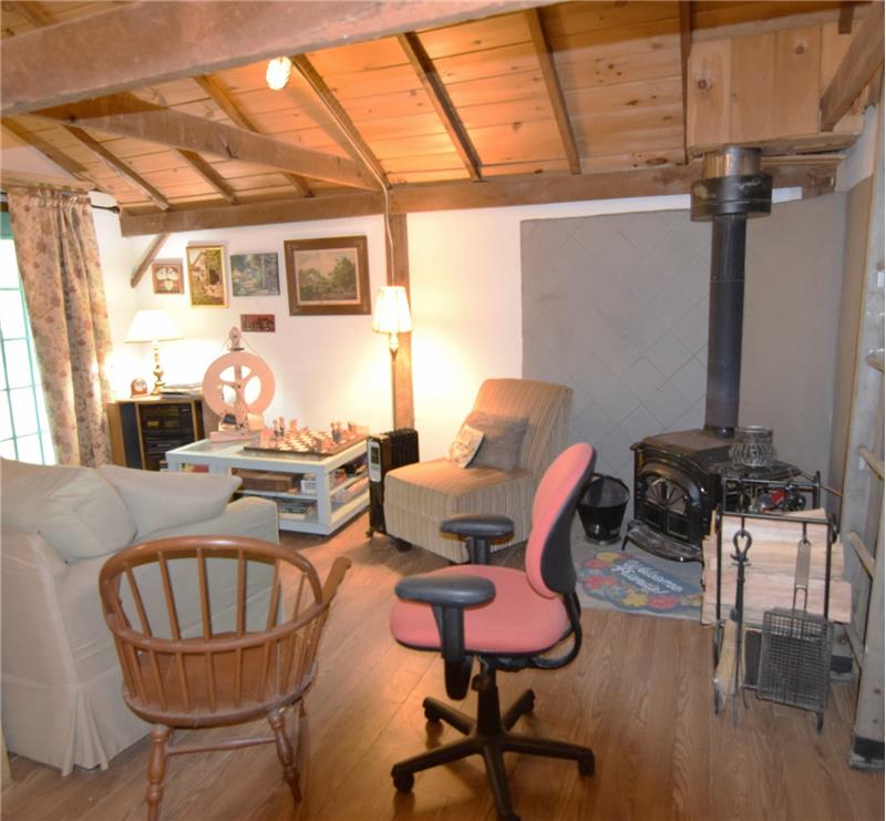 Wood-finish flooring throughout, complemented by exposed wood ceiling beams and planking
