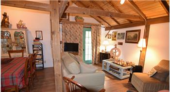 aulted wood-paneled ceiling with exposed beams
