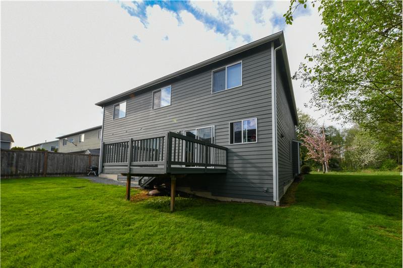 Back of the home with deck off kitchen.