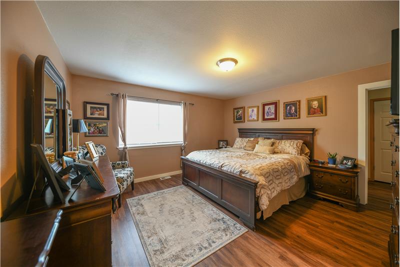 Extra large main floor primary bedroom with ensuite and walk-in closet.