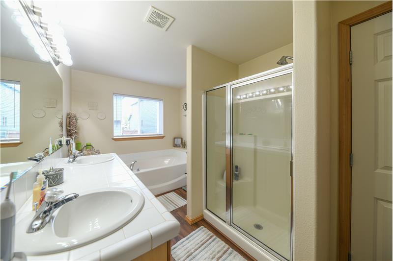 Five-piece primary bathroom with four-foot shower and garden tub.