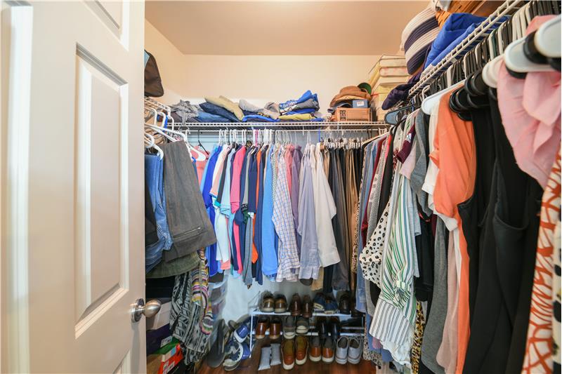 Primary walk-in closet. There's more storage space behind the door too!