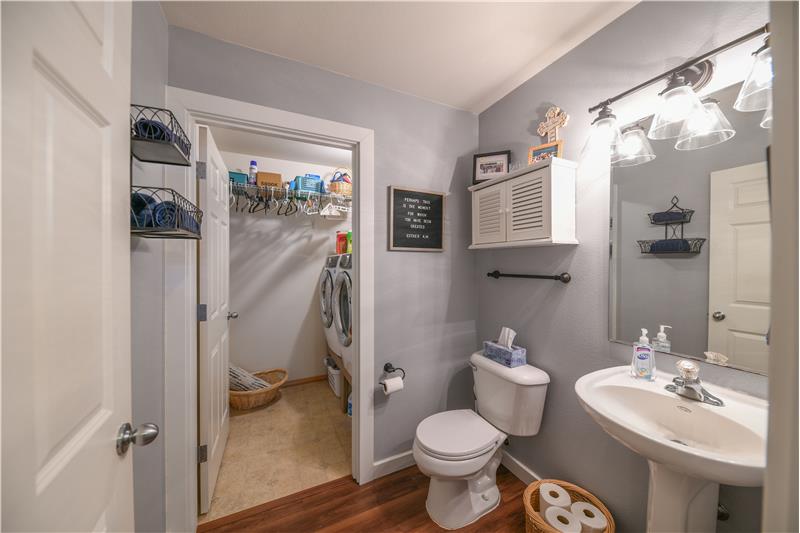 Half bathroom downstairs with laundry room.