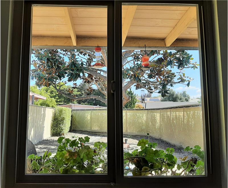 The recently expanded front overhang provides cool shade; the front window reminds you that Life is Beautiful.