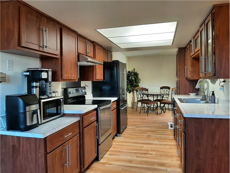The Rich Color of the Remodeled Kitchen Cabinets are mated with Brushed Nickle Hardware matching that of the Updated Appliances.