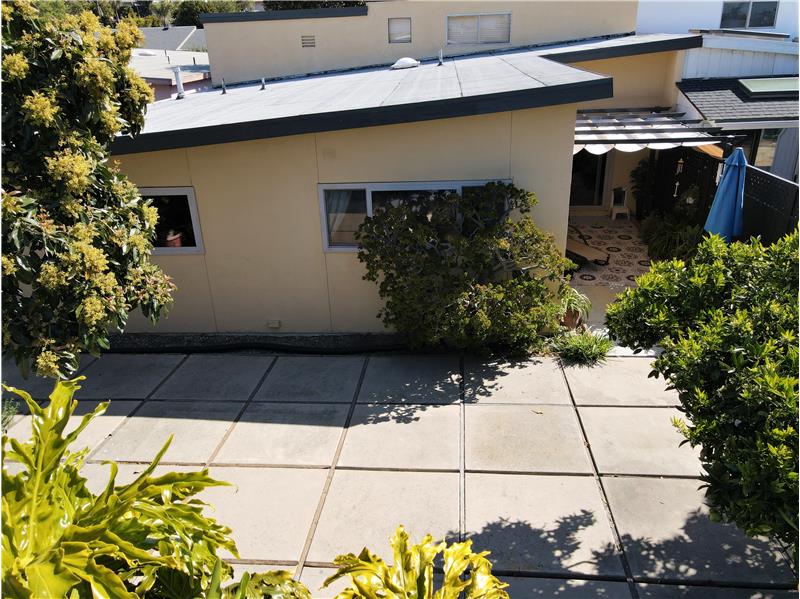 Three tab asphalt shingle in front; rolled roofing in back: this roof is watertight. Zero issues, even with all the rain.