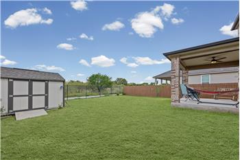 Corner lot backs up to greenbelt. Home has a covered back porch with ceiling fan. 
Storage shed with shelves and ramp.