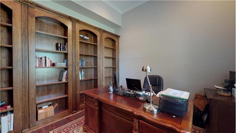 Stately study with built-in bookshelves at the front of the house