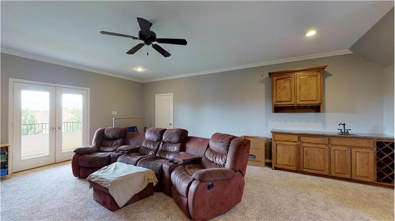 Outstanding game room with wet bar and a fantastic balcony overlooking the .68 acre lot!