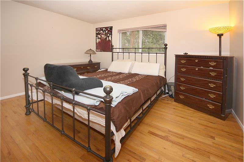 Master bedroom with hardwood flooring