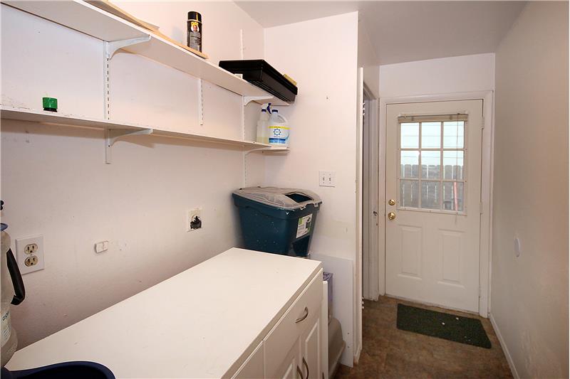 This area has laundry hook ups, storage space, and would make a nice mudroom!