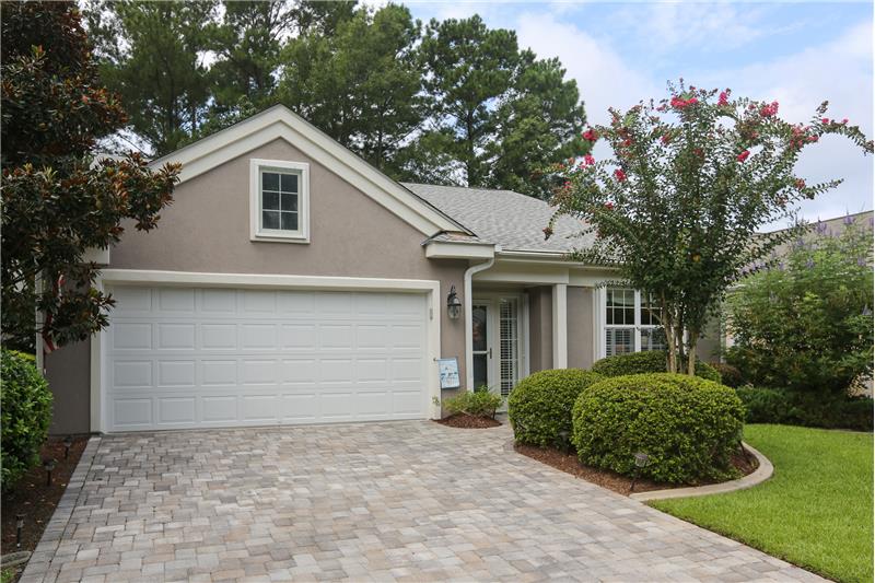Paver driveway welcomes you to this beautifully landscaped home.
