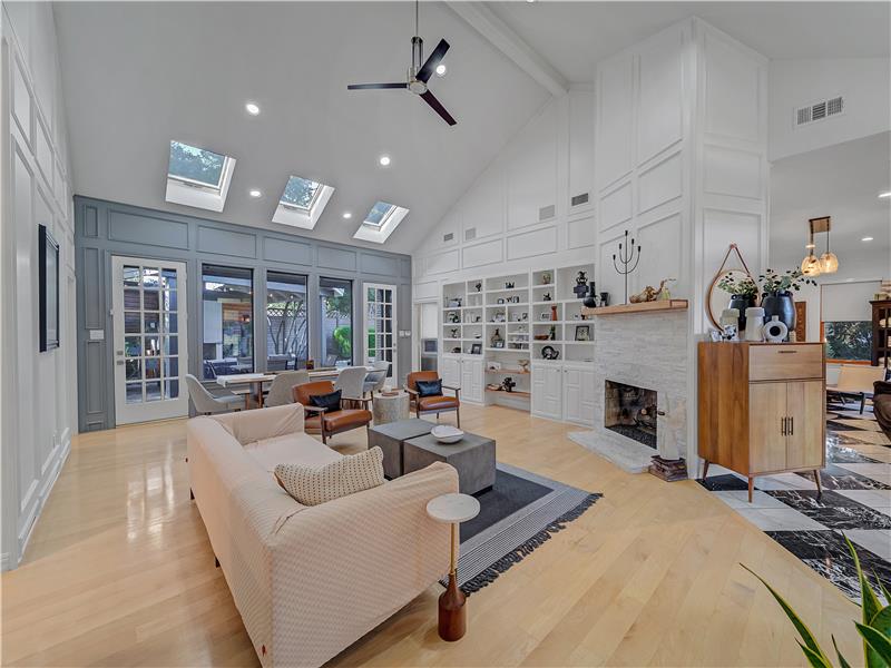 Living room with ceiling fan, beamed ceiling, light wood-type flooring, and high vaulted ceiling. Beautiful see through gas FP