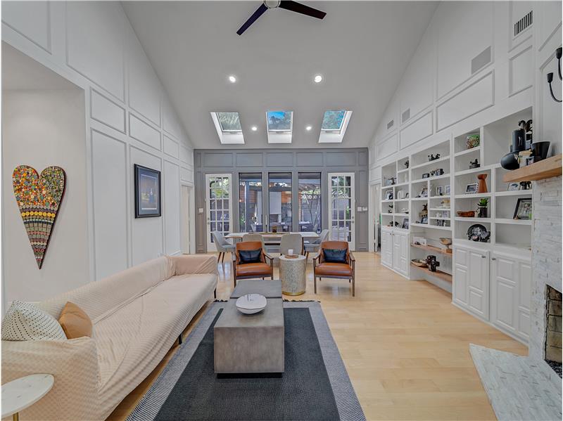 This family living area is large enough to include a dining table. Large windows bring in lots of light