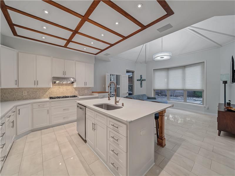 Kitchen featuring appliances with stainless steel finishes, decorative backsplash, sink, white cabinets