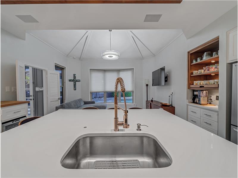 Kitchen with white cabinets and SS sink