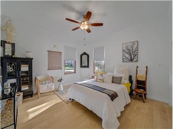 Bedroom featuring light wood-type flooring and ceiling fan