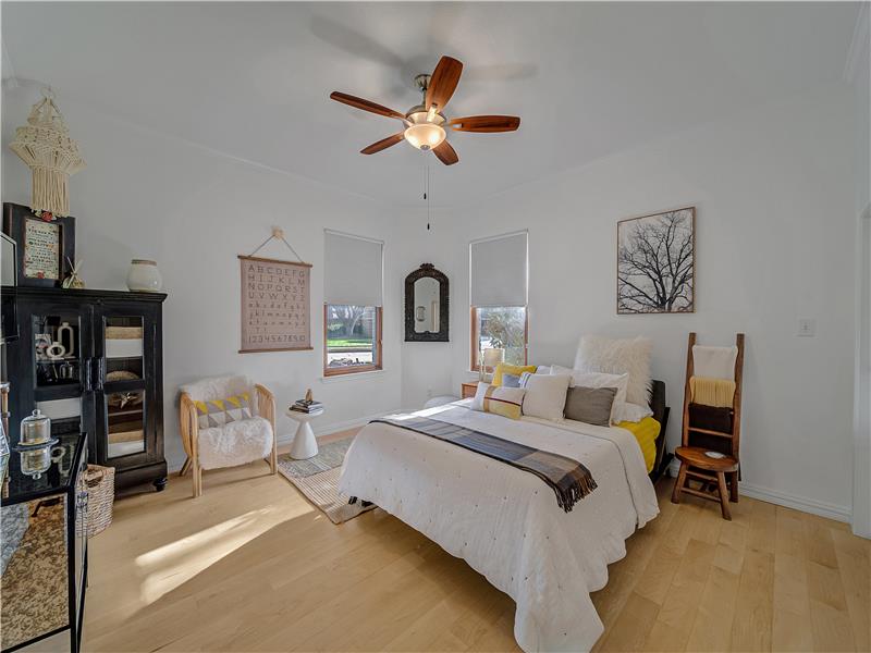 Bedroom featuring light wood-type flooring and ceiling fan