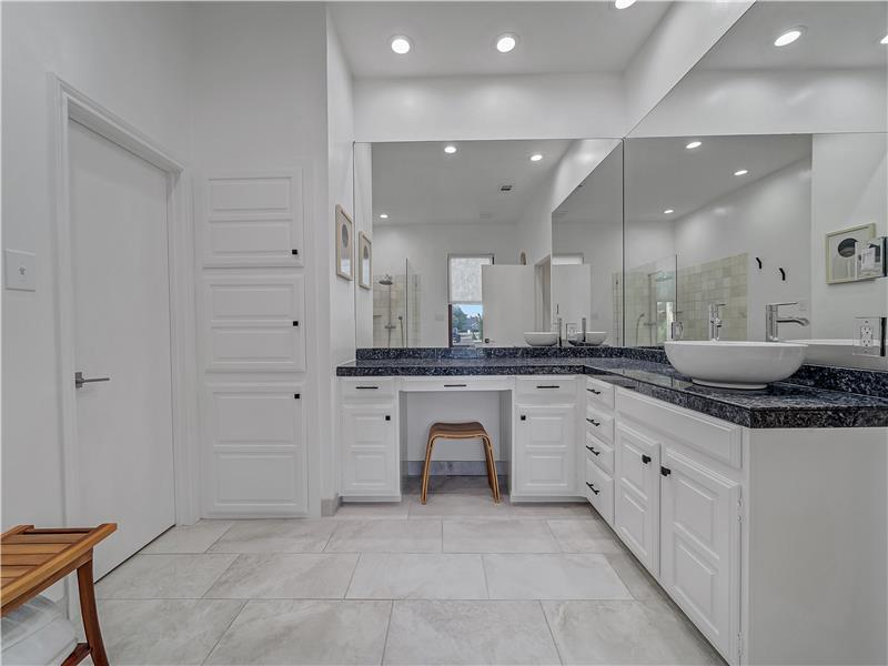 Bathroom featuring walk in shower and vanity