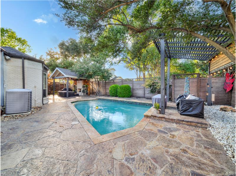 View of pool with area for grilling, cooling unit, a gazebo, and a pergola