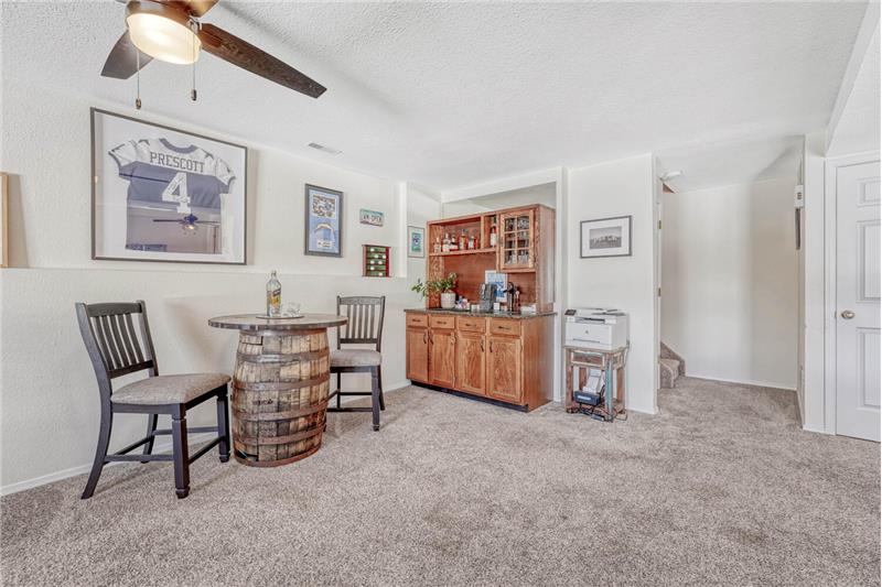 Large rec room with wet bar and under stair storage