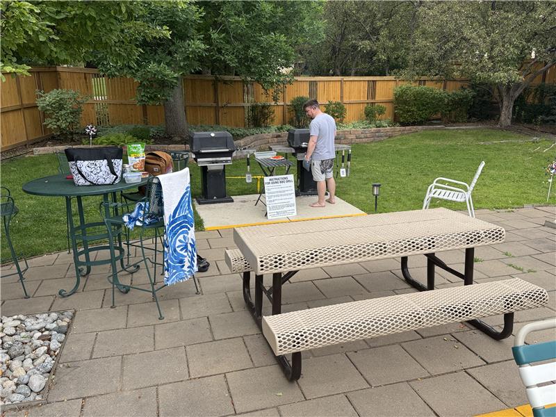 2 gas grills and picnic table in pool area