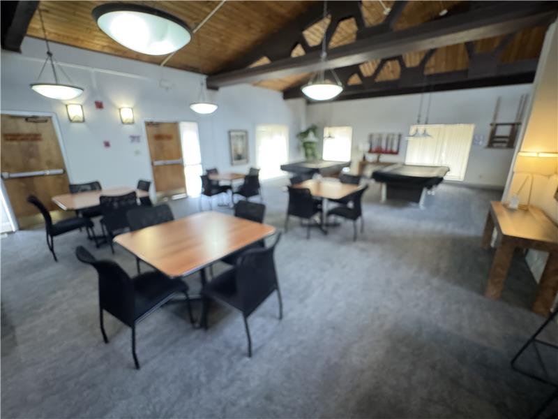 Clubhouse eating area with pool tables beyond