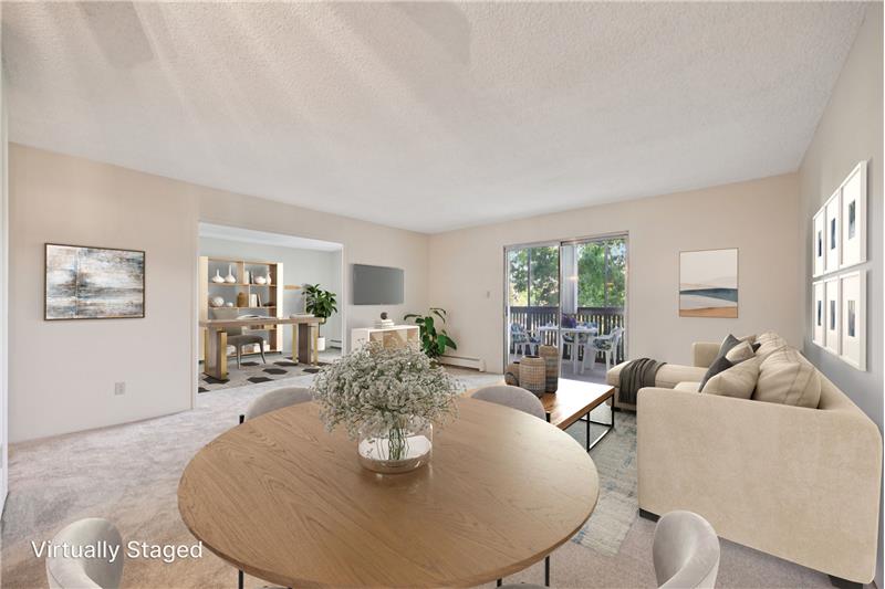 View of dining/living room from kitchen (virtually staged)