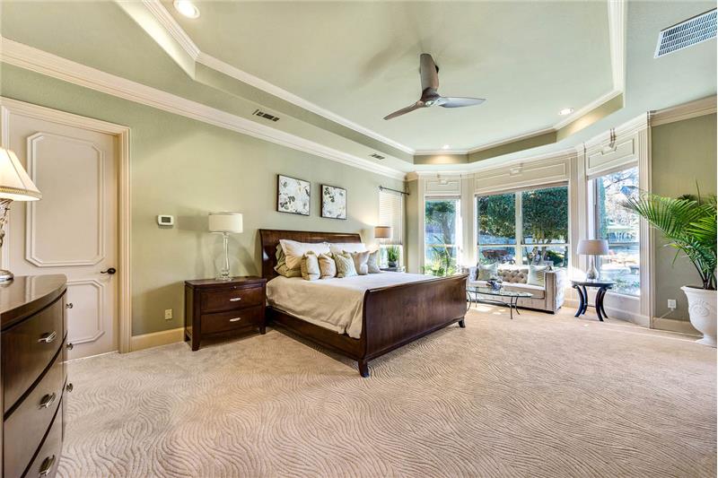 Large master suite with views of pool and backyard access