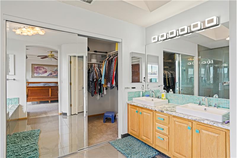 Behind mirrored bypass doors is large walk-in closet. 