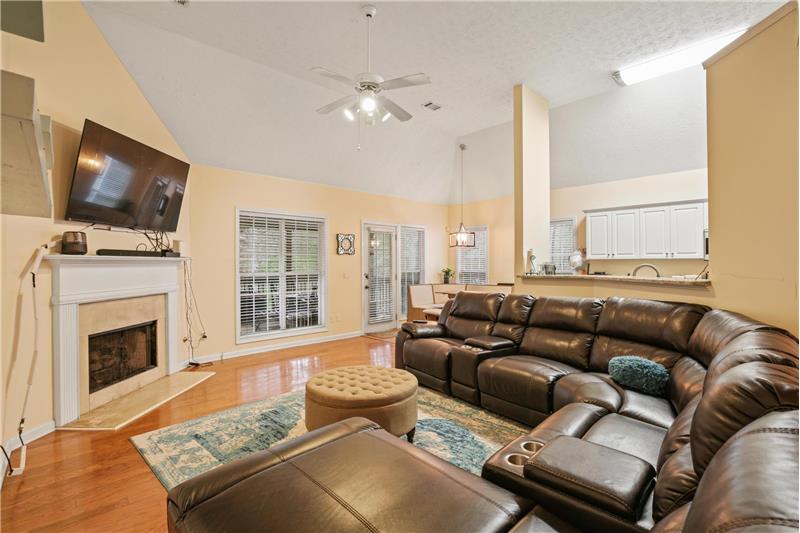 Gas log fireplace and view to kitchen & dining areas