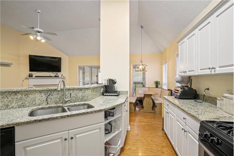 Granite counters, white cabinetry and open view