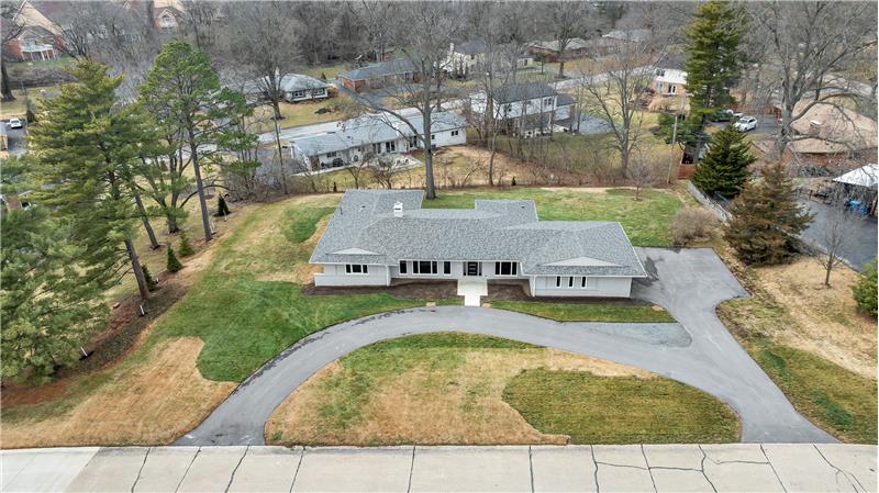 This view shows the back yard, patio's and replaced architectural roof.