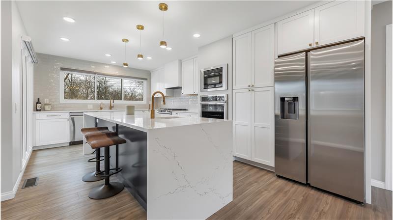 Amazing custom kitchen. Cambria Quartz counters, Samsung appliances, 5 burner gas stove