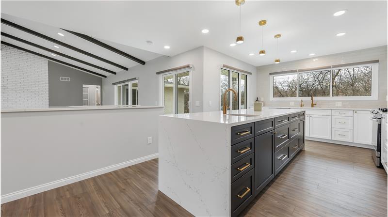 Kitchen Island has a beverage sink, soft close drawers, pendant & recessed lighting.