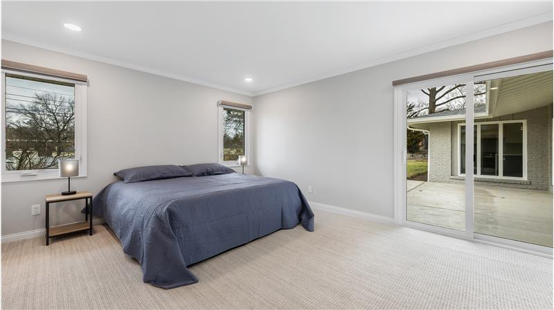 Spacious master bedroom with a door to the patio.