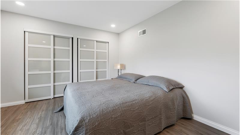 Bedroom #2. showing a king size bed. recessed lighting