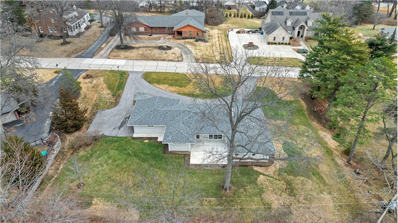 his view shows the back yard, patios and replaced architectural roof.