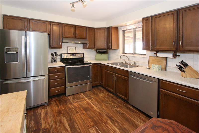 Kitchen with stainless steel appliances and tile backsplash