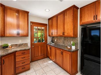 Plenty of cabinets for food storage, dishes and gadgets.  Side door out to the side deck & BBQ area.