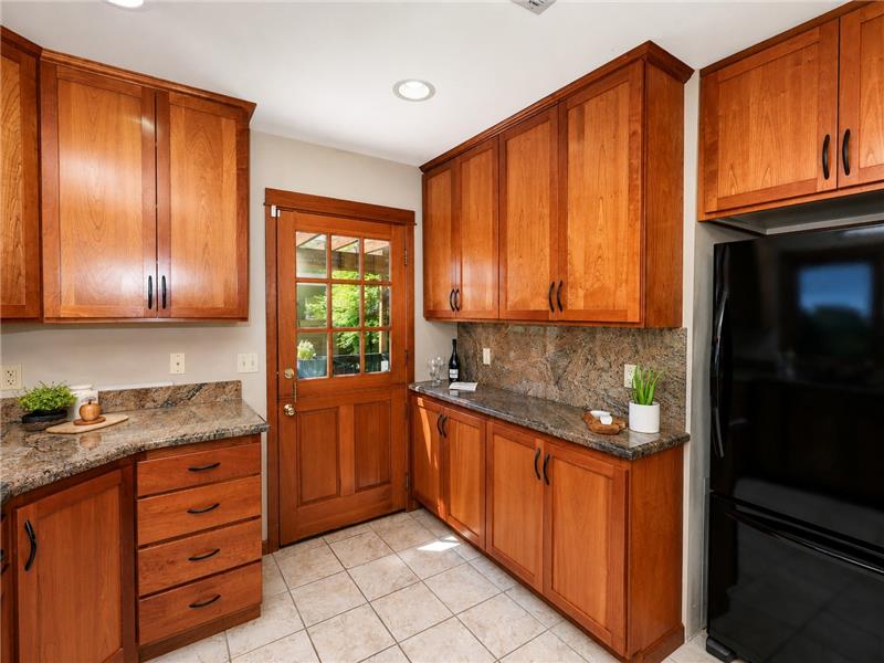 Plenty of cabinets for food storage, dishes and gadgets.  Side door out to the side deck & BBQ area.