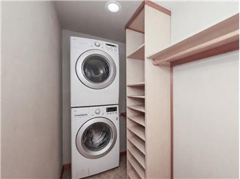 Washer & dryer hook ups in the primary walk-in closet. The stackable washer and dryer shown are virtual.