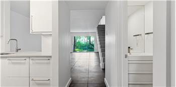 Modern Kitchen on left, Half Bath Bath for Guests on the Right