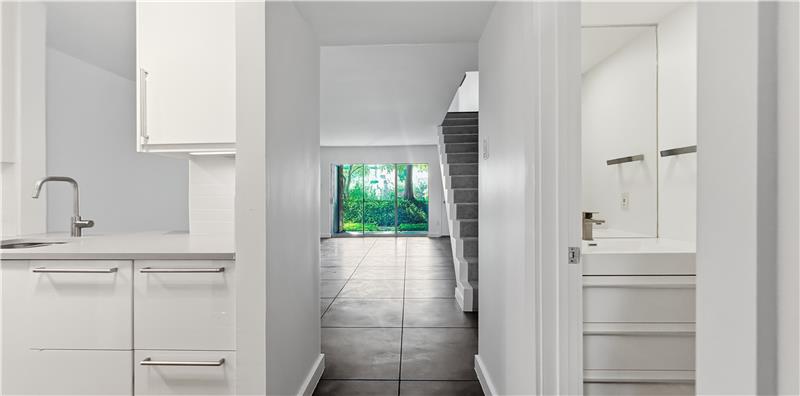 Modern Kitchen on left, Half Bath Bath for Guests on the Right